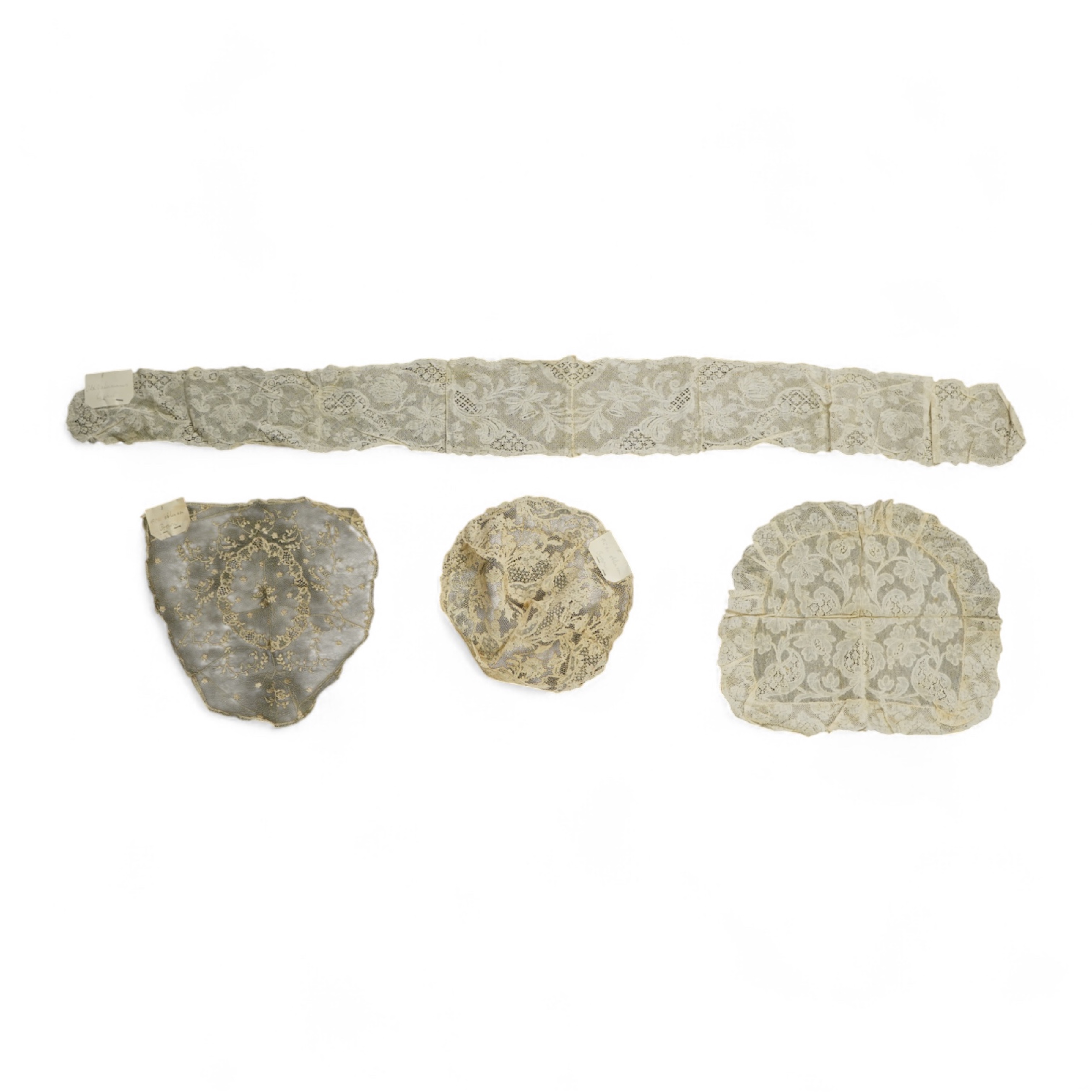 A collection of 18th century needle and bobbin lace. Including an 18th century wide pair of joined Valenciennes lace lappets, a similar 18th century cap back, an ornately worked Point de Alencon cap crown and another sim